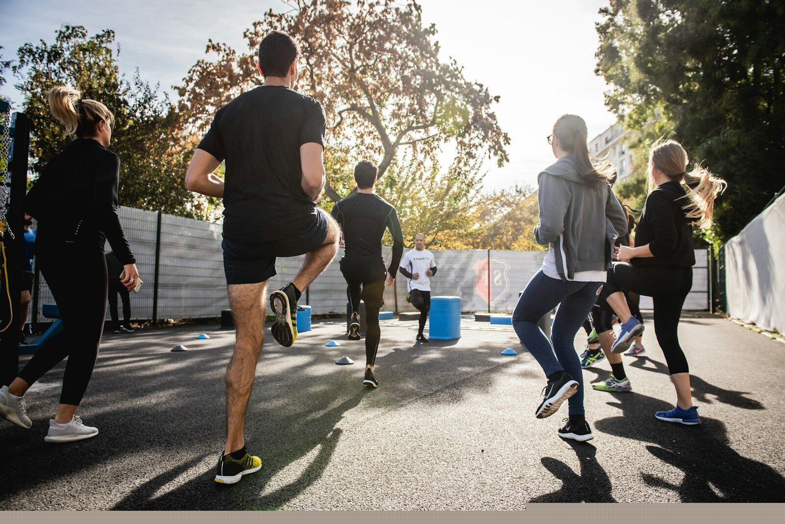 man in black t-shirt and black shorts running on road during daytime