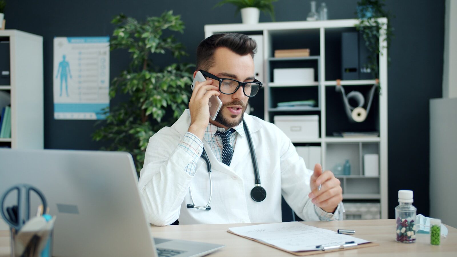 Doctor talking on the phone in his office